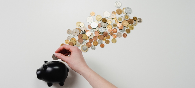 a black piggy bank and coins