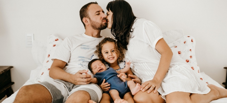 man and woman with their kids thinking why moving to Schulenburg TX with your family is a great idea