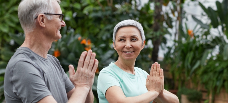 una pareja de adultos mayores haciendo yoga