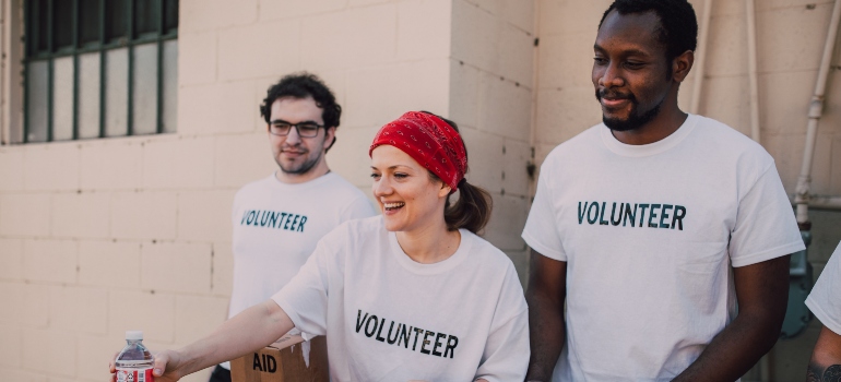 three people volunteering and making friends in Dallas