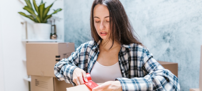 woman packing a moving box