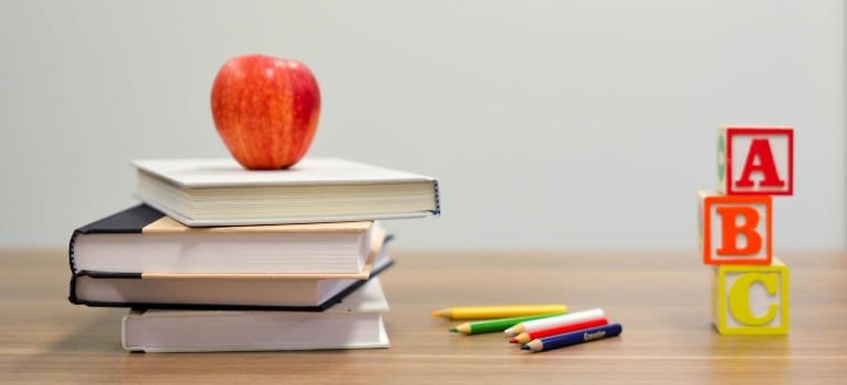 books and crayons on a desk