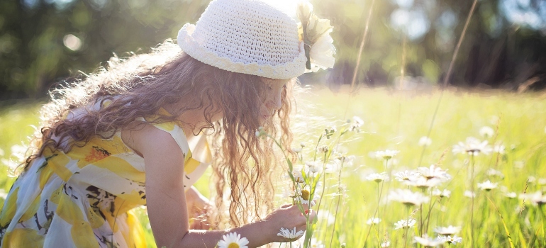 a girl picking flowers in one of the top Houston suburbs for young professionals