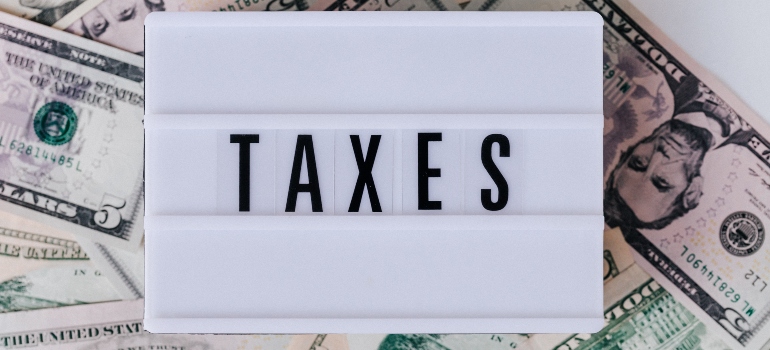 a board with the word "taxes" written 