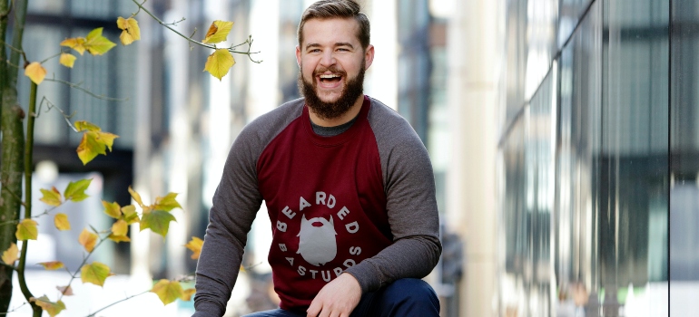 a man laughing thinking about the reasons young people are leaving Houston for Chicago