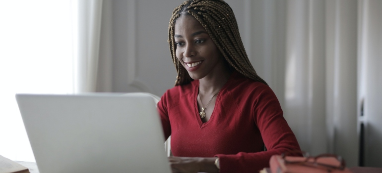 a woman looking at a laptop 