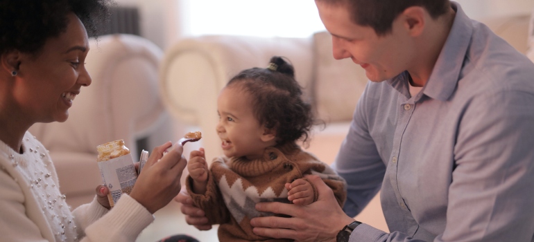 a couple feeding their baby