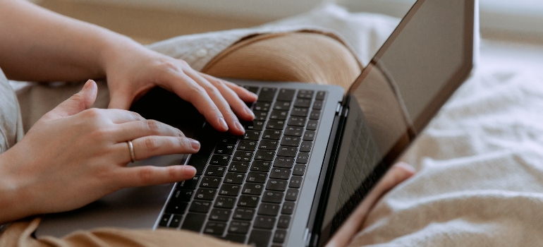 a person typing something on a laptop